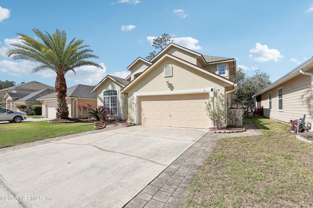 traditional home with stucco siding, an attached garage, driveway, and a front yard