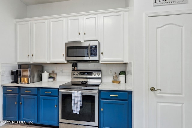 kitchen with blue cabinetry, tasteful backsplash, appliances with stainless steel finishes, and white cabinetry