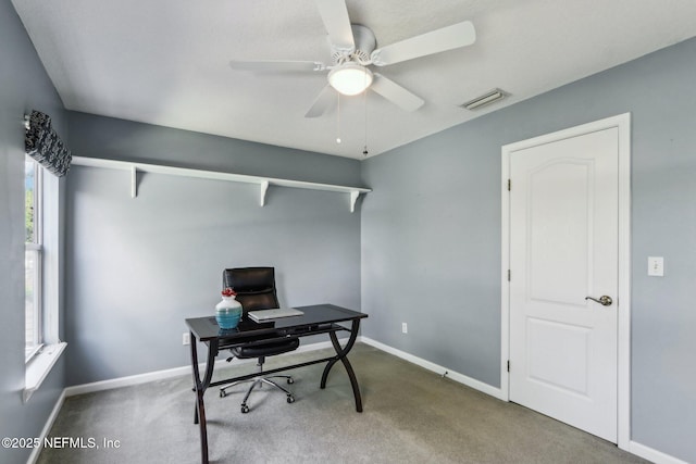 office space featuring visible vents, carpet floors, baseboards, and ceiling fan