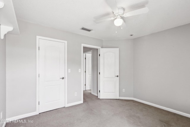 unfurnished bedroom with visible vents, carpet flooring, a ceiling fan, and baseboards