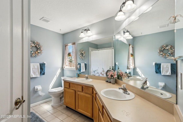 full bathroom featuring visible vents, toilet, and a sink