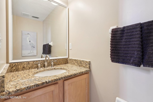 bathroom with vanity and visible vents