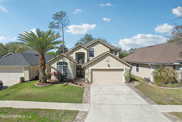 traditional home featuring a front yard, concrete driveway, an attached garage, and stucco siding