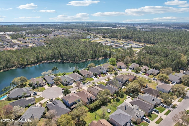 aerial view with a residential view, a water view, and a view of trees