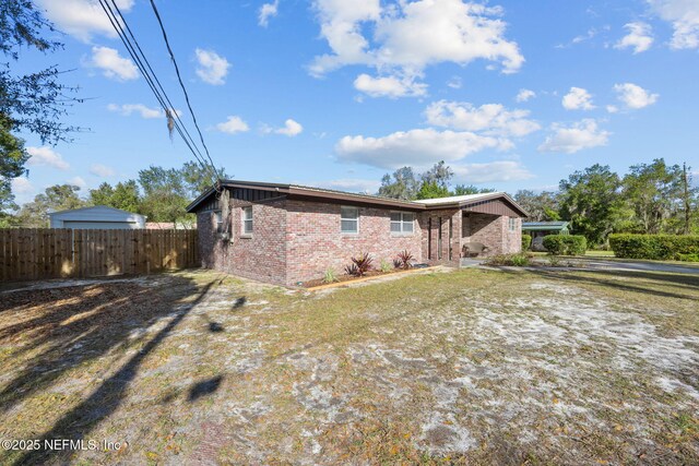 1516 Prospect St, Palatka, FL 32177 - back of property with brick siding and fence