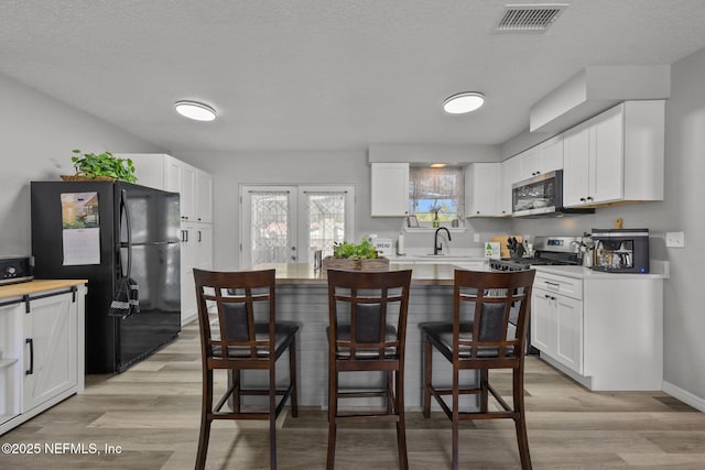 1516 Prospect St, Palatka, FL 32177 - kitchen with a sink, visible vents, appliances with stainless steel finishes, and white cabinets
