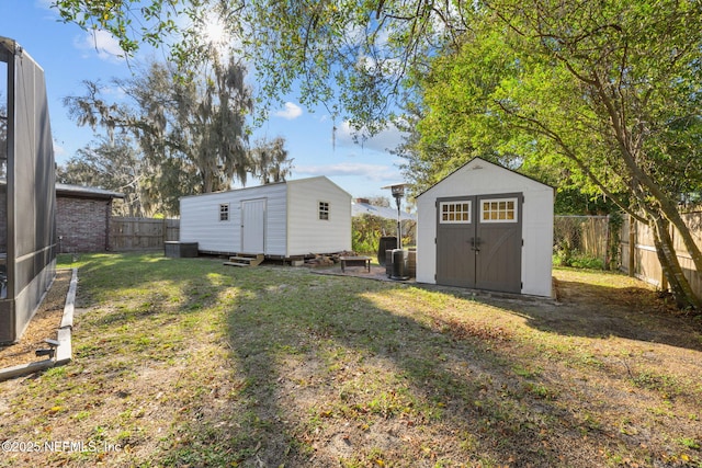 1516 Prospect St, Palatka, FL 32177 - view of yard with an outbuilding, central AC, a fenced backyard, and a storage shed