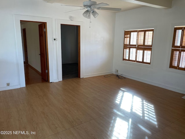 unfurnished room featuring baseboards, wood finished floors, and a ceiling fan