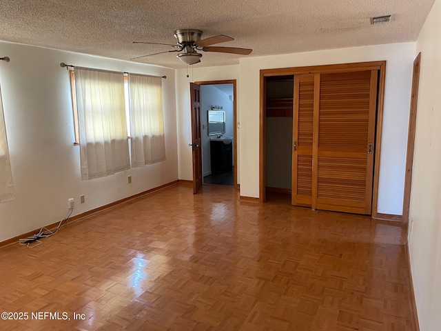 unfurnished bedroom featuring baseboards, visible vents, a closet, and a textured ceiling