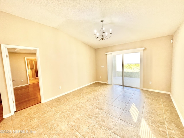 empty room with baseboards, lofted ceiling, a notable chandelier, and a textured ceiling