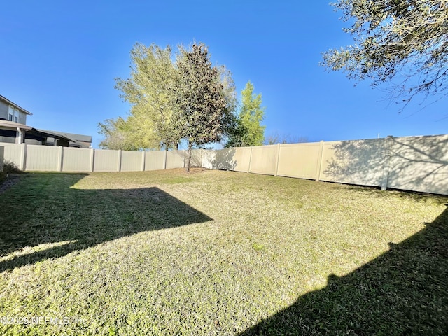 view of yard with a fenced backyard