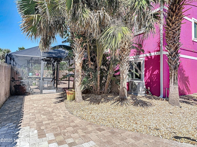 view of yard featuring a lanai and fence