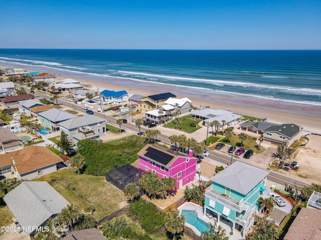 birds eye view of property featuring a beach view and a water view