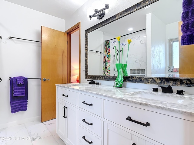 bathroom with a sink, a shower with curtain, marble finish floor, and double vanity