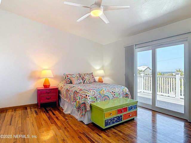 bedroom featuring baseboards, wood finished floors, access to exterior, and a ceiling fan