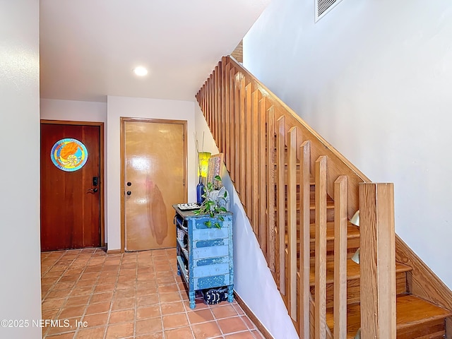 stairs with tile patterned flooring, visible vents, and recessed lighting