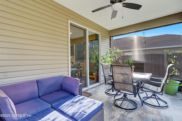 view of patio with outdoor dining space, fence, and ceiling fan