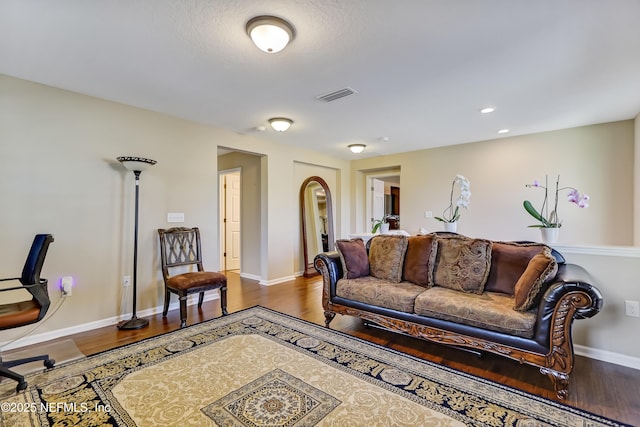 living room with visible vents, recessed lighting, baseboards, and wood finished floors