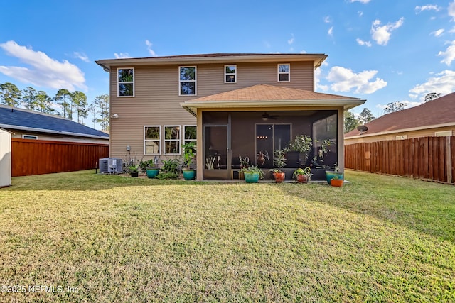 back of property featuring a lawn, central AC, a fenced backyard, and a sunroom