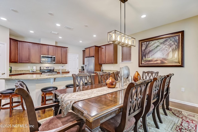 dining area with recessed lighting, visible vents, baseboards, and light wood finished floors