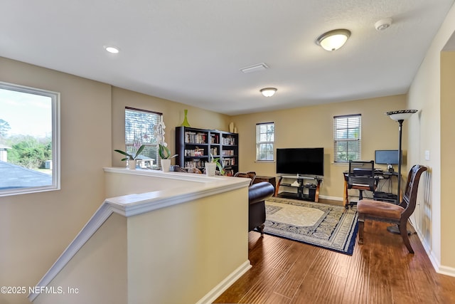 living area featuring wood finished floors and baseboards