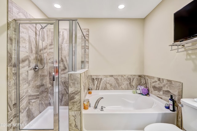 bathroom featuring toilet, a shower stall, a bath, and recessed lighting