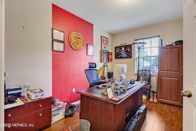 office featuring baseboards, a textured ceiling, and wood finished floors