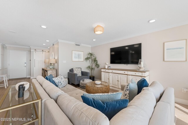 living room with recessed lighting, visible vents, and ornamental molding