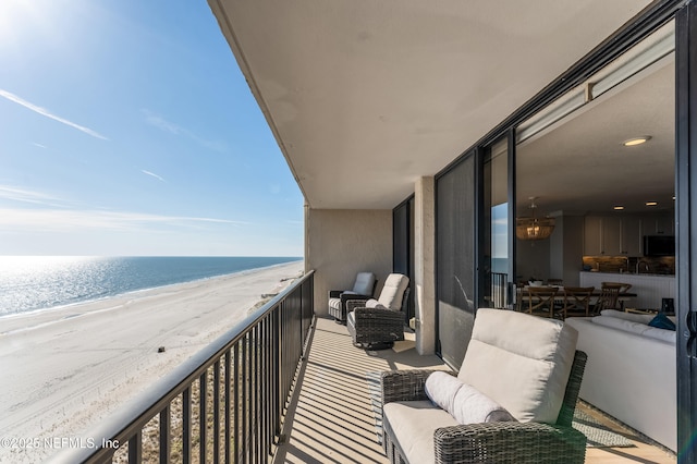 balcony featuring a water view and a view of the beach