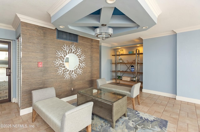 interior space featuring baseboards, an accent wall, and crown molding