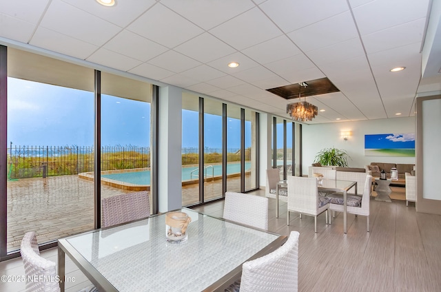 sunroom / solarium featuring a paneled ceiling