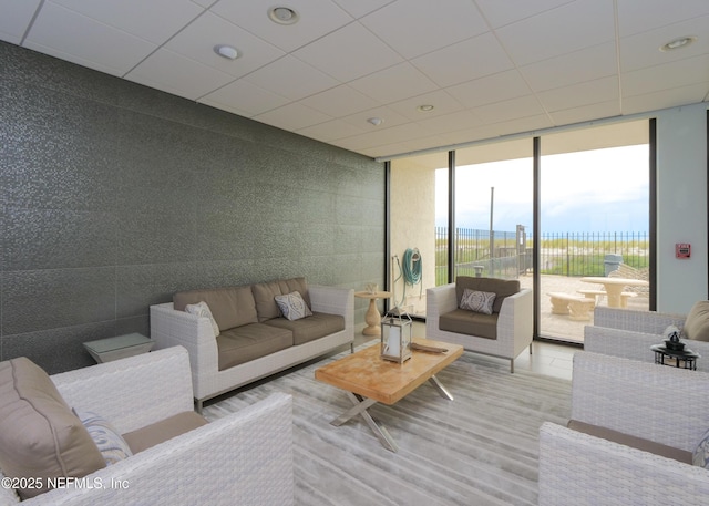 living room with expansive windows and a paneled ceiling