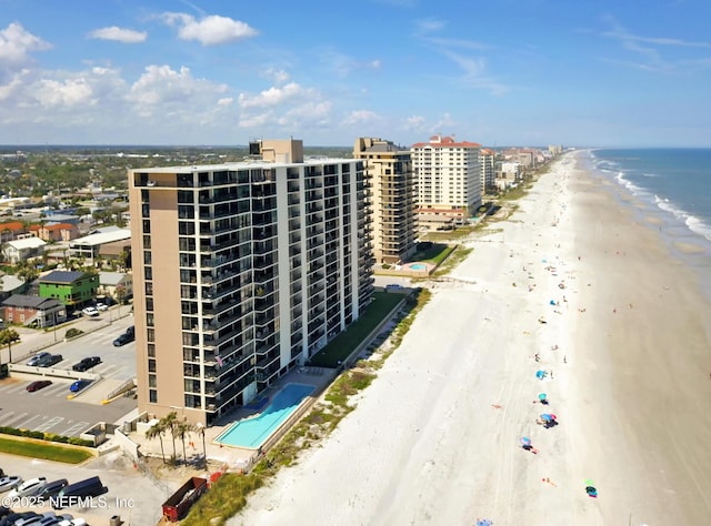 drone / aerial view featuring a water view and a beach view