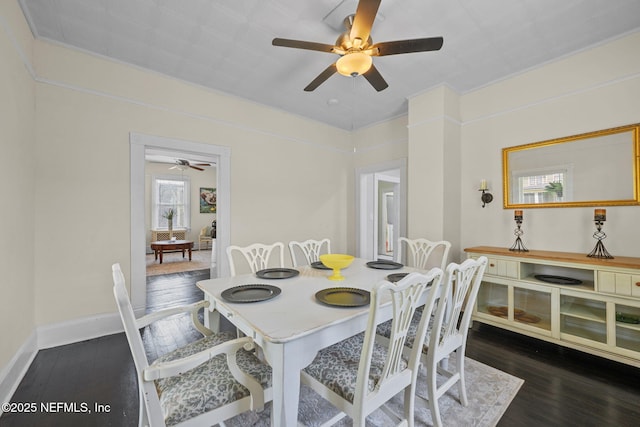 dining area with baseboards and wood finished floors