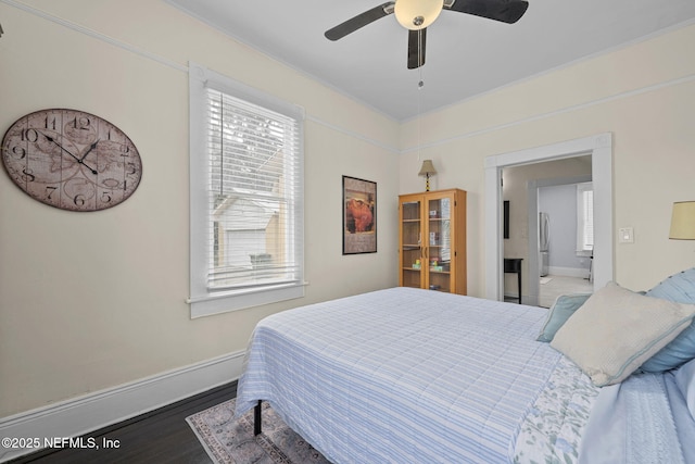 bedroom featuring ceiling fan, baseboards, and wood finished floors