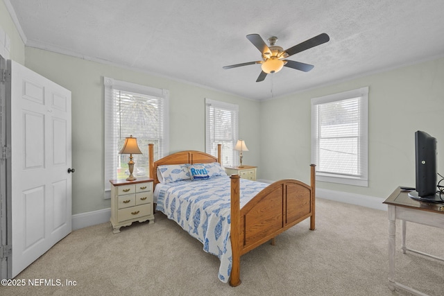 bedroom featuring light colored carpet, a textured ceiling, crown molding, and multiple windows