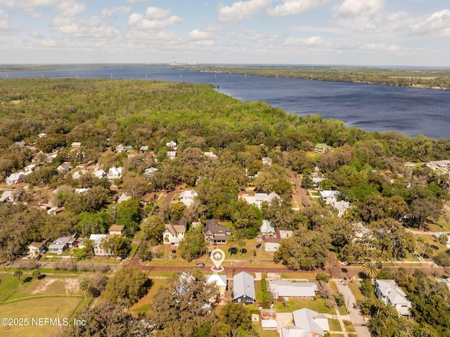 bird's eye view featuring a wooded view and a water view