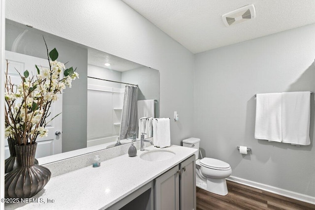 full bathroom with a shower with shower curtain, wood finished floors, visible vents, baseboards, and toilet