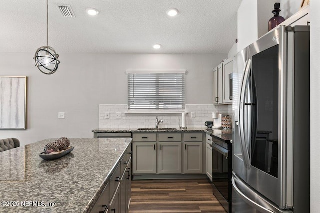 kitchen featuring backsplash, black range with electric stovetop, dark wood-style floors, and refrigerator with glass door