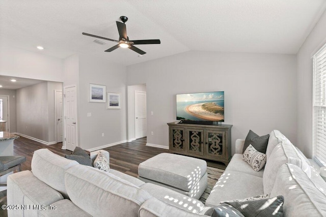 living room with visible vents, a ceiling fan, wood finished floors, baseboards, and vaulted ceiling