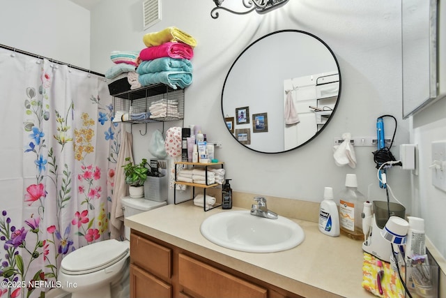 full bath with visible vents, toilet, vanity, and a shower with curtain