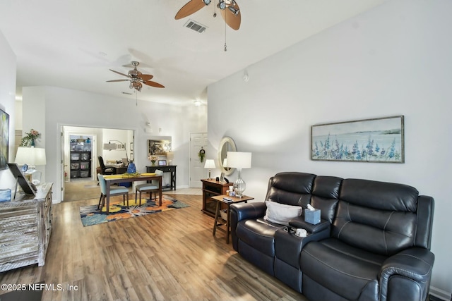 living area featuring wood finished floors, a ceiling fan, and visible vents