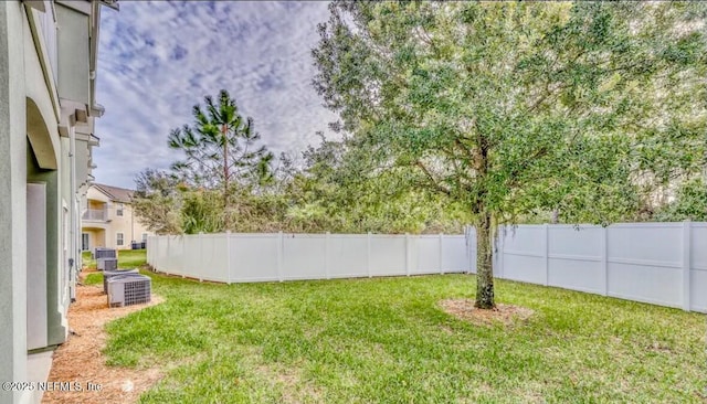 view of yard featuring central air condition unit and fence