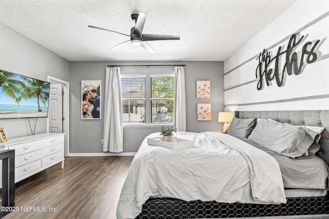 bedroom featuring baseboards, a textured ceiling, ceiling fan, and wood finished floors