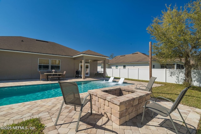 view of swimming pool featuring a fenced in pool, a patio area, fence, and a fire pit