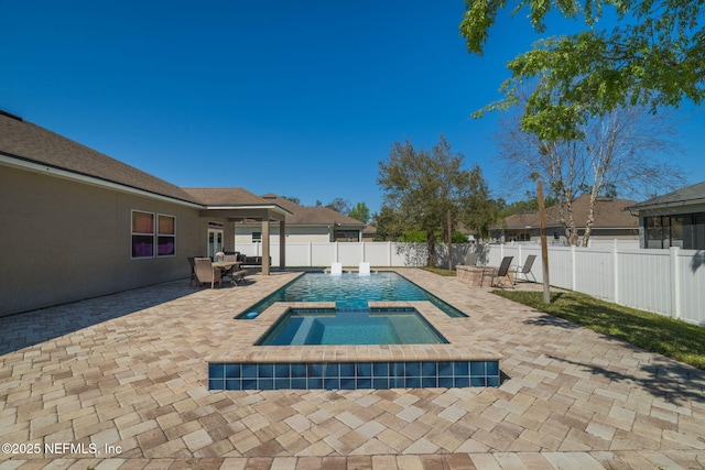 view of swimming pool featuring a fenced in pool, an in ground hot tub, a fenced backyard, and a patio area