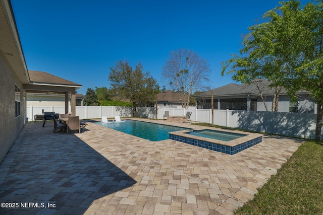 view of pool with outdoor dining space, a fenced in pool, an in ground hot tub, a fenced backyard, and a patio area