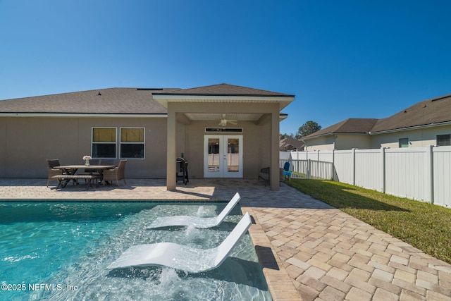 view of swimming pool with a patio, fence, french doors, a grill, and ceiling fan