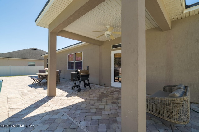 view of patio featuring visible vents, ceiling fan, fence, outdoor dining space, and a grill