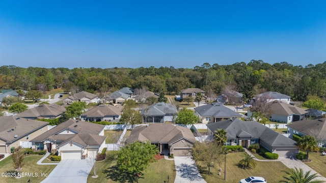 birds eye view of property with a residential view and a wooded view